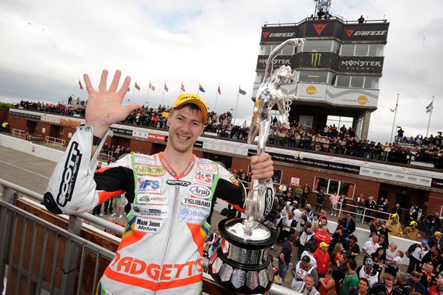Ian Hutchinson celebrates making history at the 2010 Isle of Man TT
